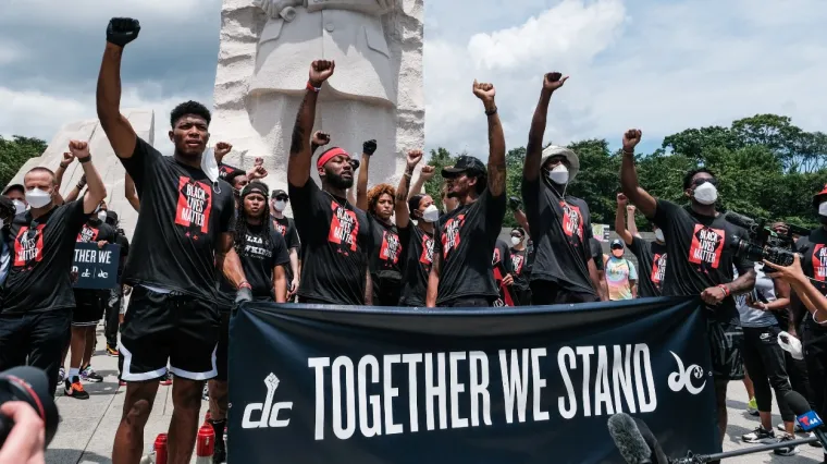 Members of the Washington Wizards and Washington Mystics