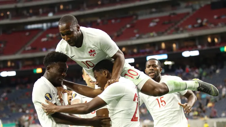 Jonathan David and the Canada squad celebrates a goal