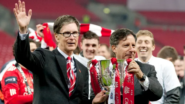 John W. Henry and Tom Werner with one of several cups captured by Liverpool during Fenway Sports Group's era as owners