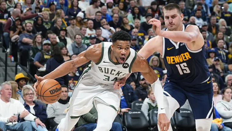 Giannis Antetokounmpo and Nikola Jokić battle it out (AP Photo/David Zalubowski)